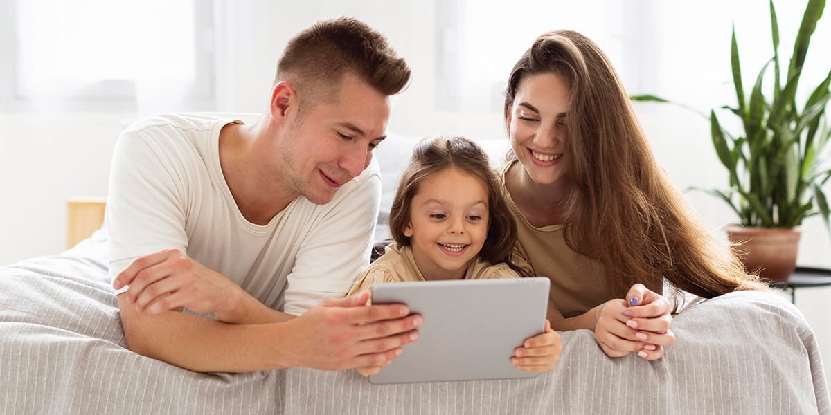 family looking at a tablet with parental controls