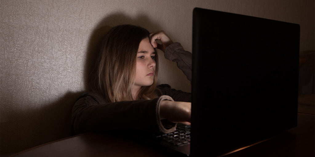 Teenager girl suffering internet cyber bullying