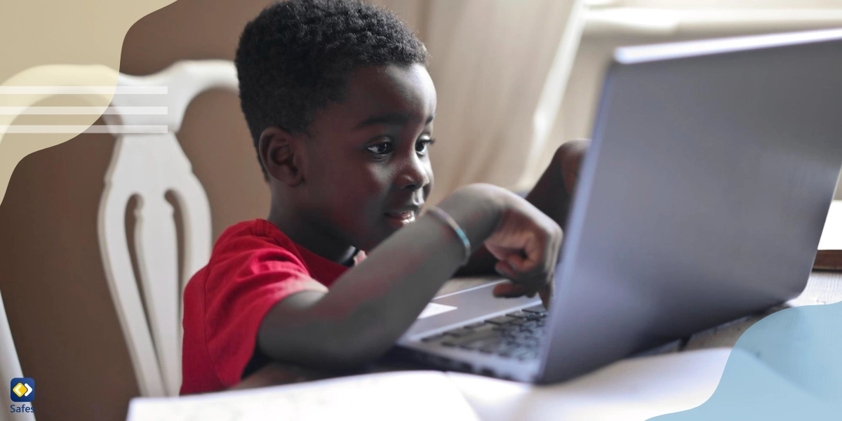 A child searching online using a safe search engine for kids with his laptop