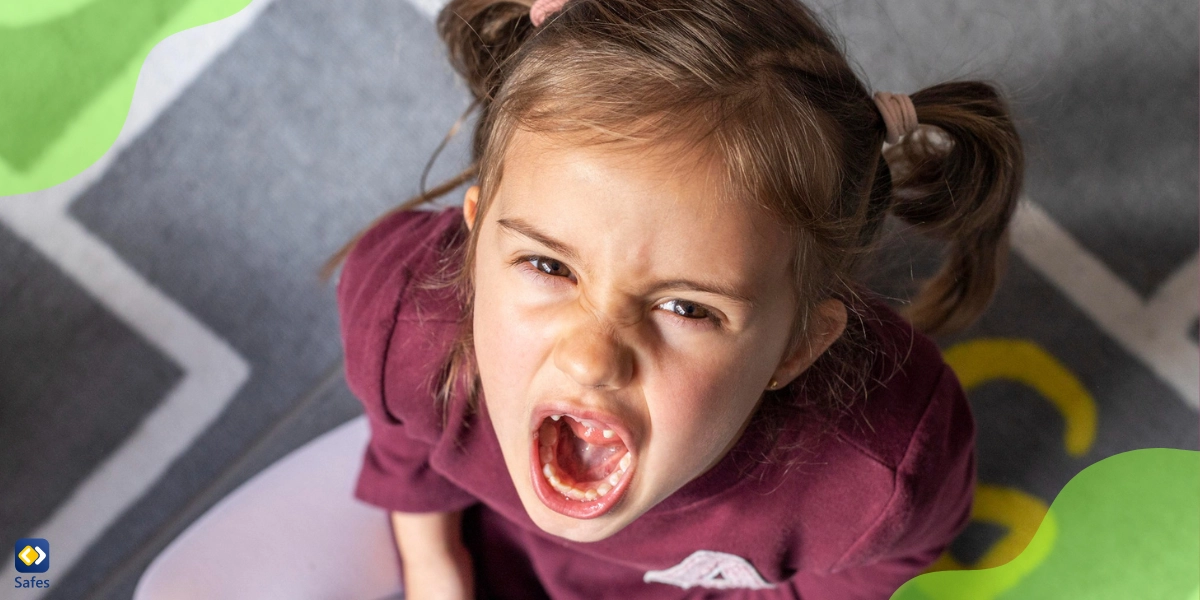 A little girl is screaming with a console in her hand