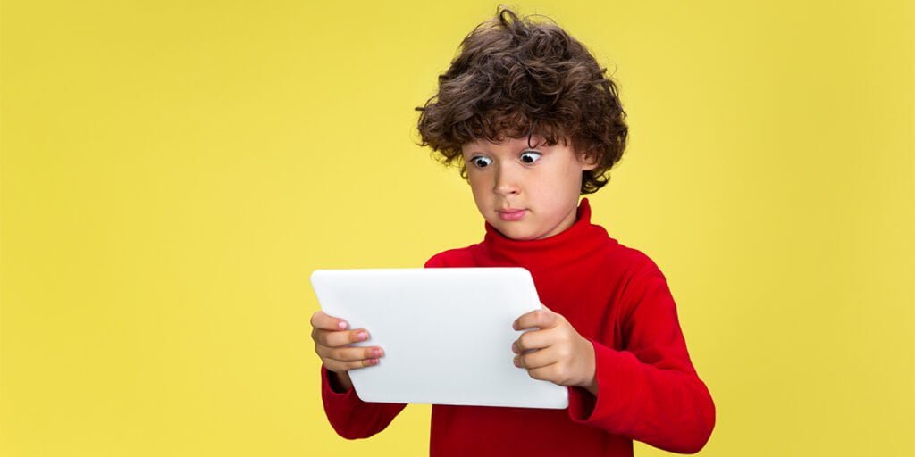 a boy using an ipad with parental controls on