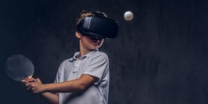 Child using a VR headset holding a table tennis pad with a ball coming toward him