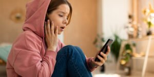 Shocked teen girl on cellphone