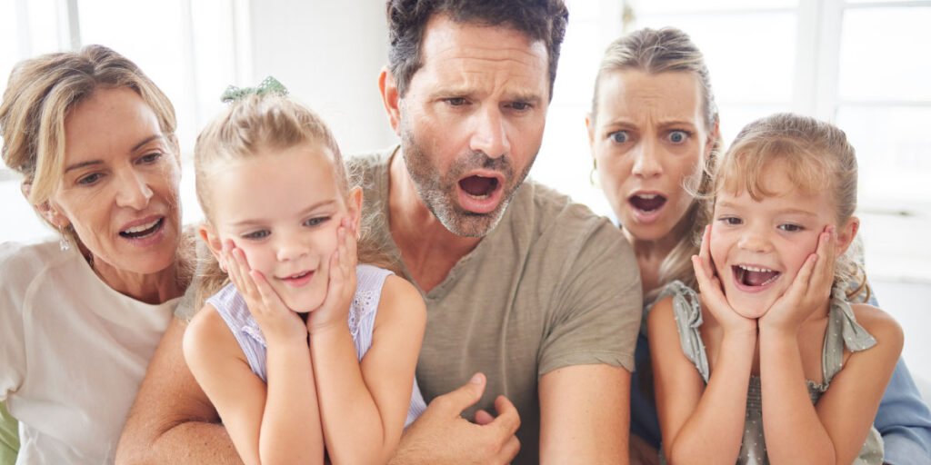 Parents and their children are looking at a laptop