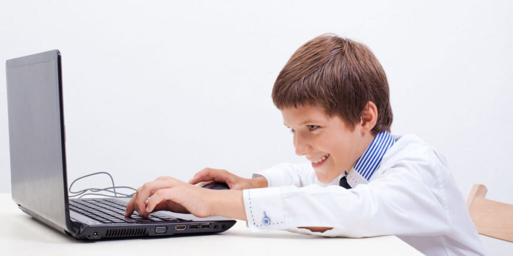 Boy in a white shirt is working with his laptop after his parents learned how to block websites on Firefox 