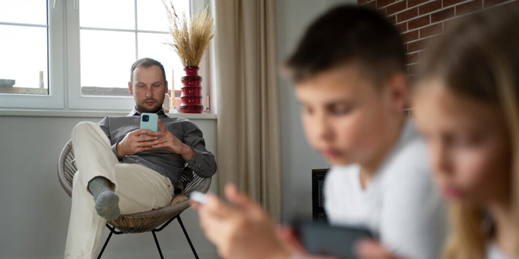 image of a father who is trying to control the use of social media from his son