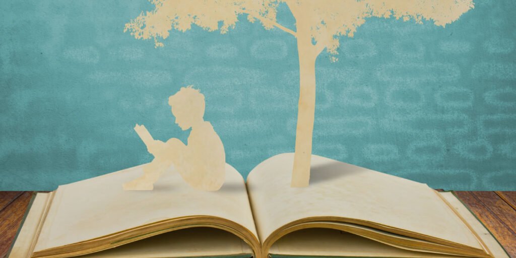 A book with silhouette of a kid and a tree sticking out
