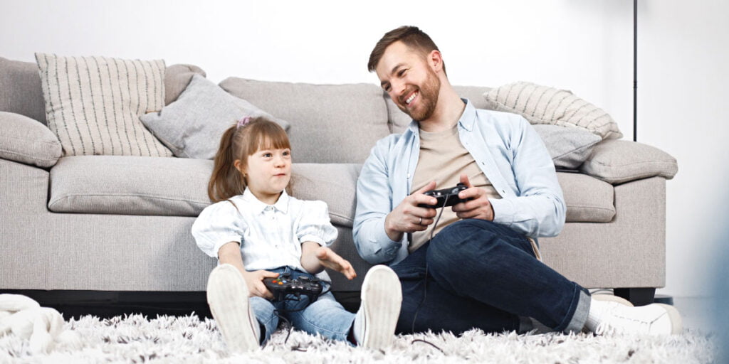 father and daughter playing a video game