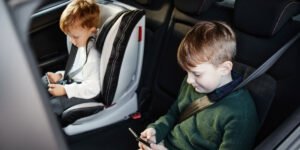 two kids who have smartphones and using Uber