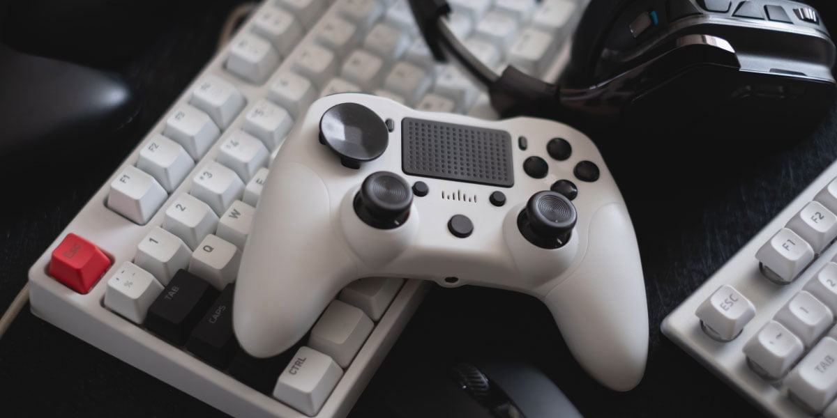 A gaming controller is on top if a keyboard