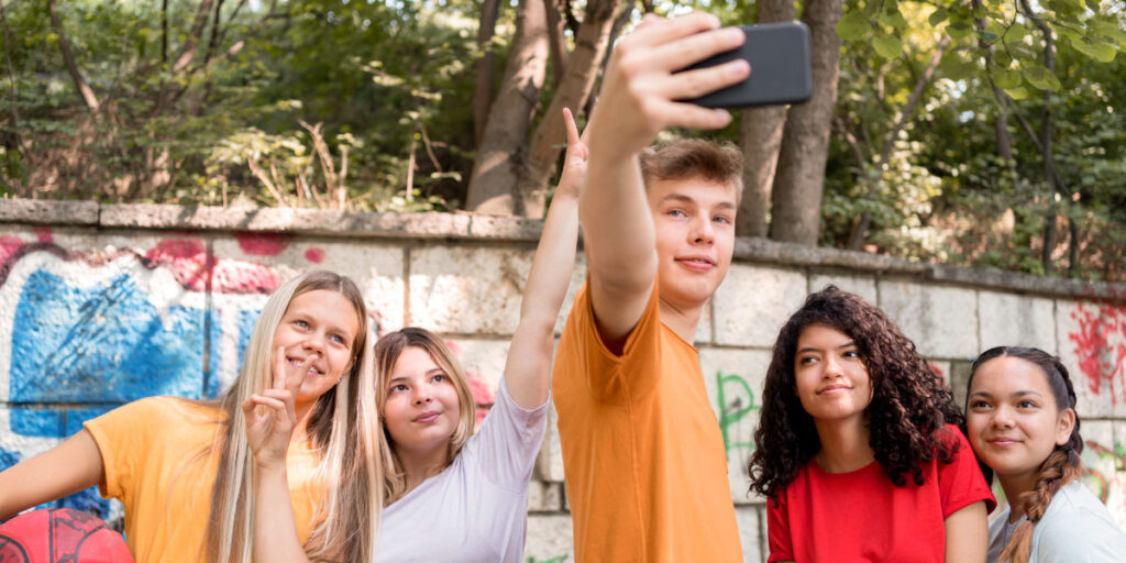 Teenagers taking selfies