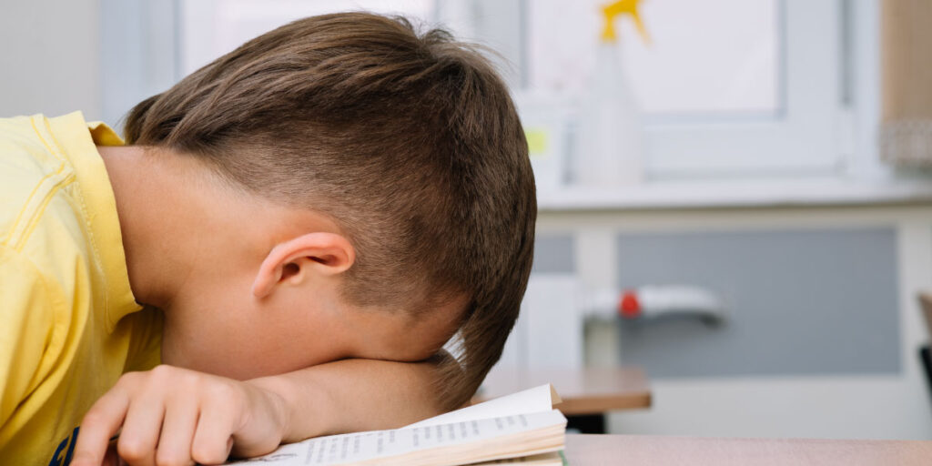 Child has put his head on a book