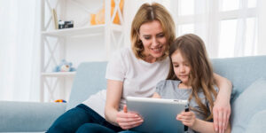 Mother and daughter using iPad.