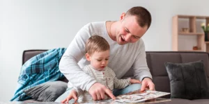 Father showing a book to their child