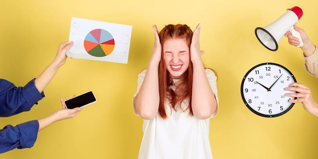 Stressed out girl with hands on her head with the stressors shown