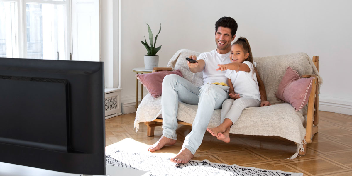 father watching tv with his daughter