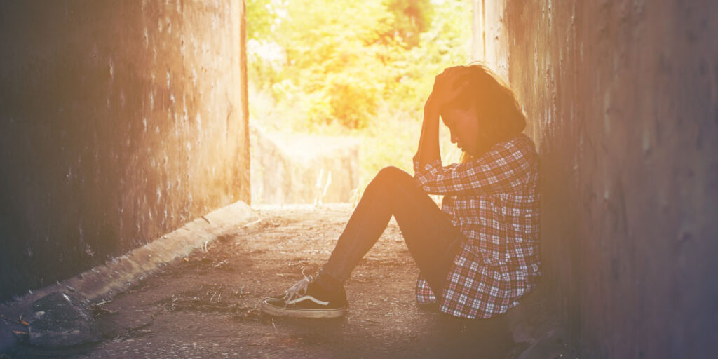 Unhappy girl sitting on the floor