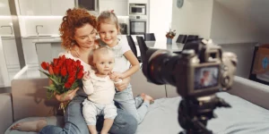 Mother with her two daughters sitting in front of a camera