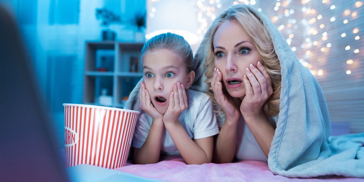 Mother and daughter watching a horror movie