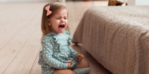Little girl crying on the floor
