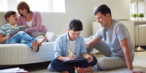 vierköpfige Familie, die Zeit miteinander beim Lesen und Spielen verbringt