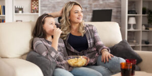 Funny movies to watch with kids. Mother and daughter watching funny movies