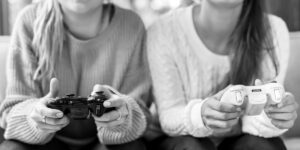 Two girls playing video games together