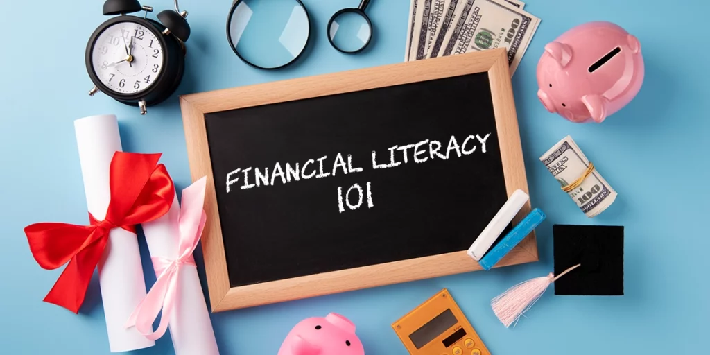The items that a child needs for financial literacy with a small blackboard in the middle, which reads "Financial Literacy 101”