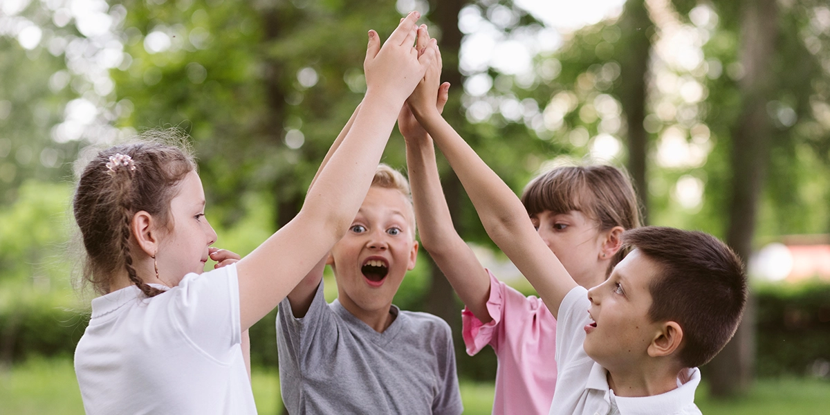 Boys and girls holding hands as if they're a team