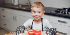 Preschooler cooking dough and laughing