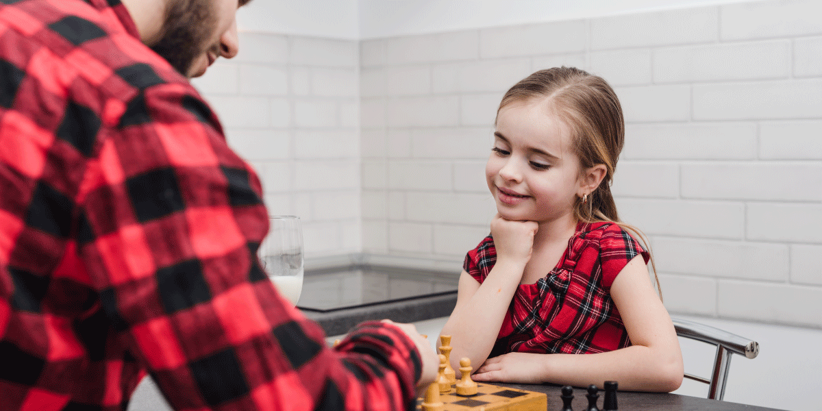 father and daughter playing chess