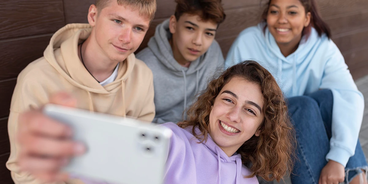 Teenagers taking a selfie together