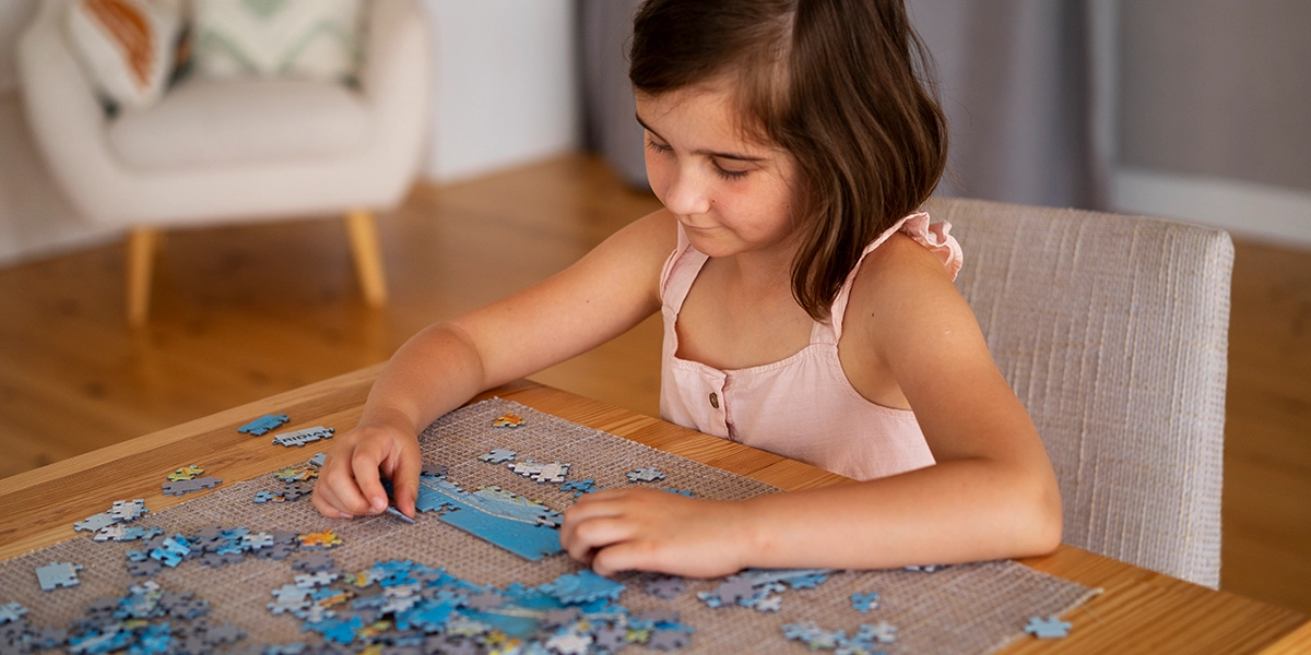 Girls making a jigsaw puzzle