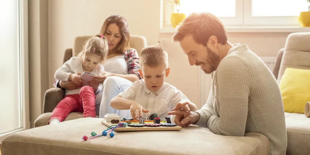 Parents playing a family board game with a child