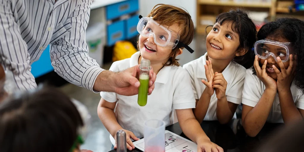 Happy kids at elementary school in a creative classroom