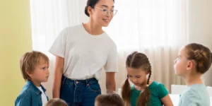 Happy kindergarteners standing in front of their happy teacher