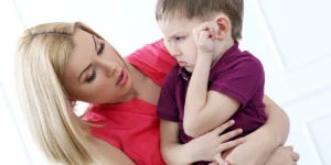 Mother with a toddler who is in a bad mood and doesn't seem like wanting to listen to his mother