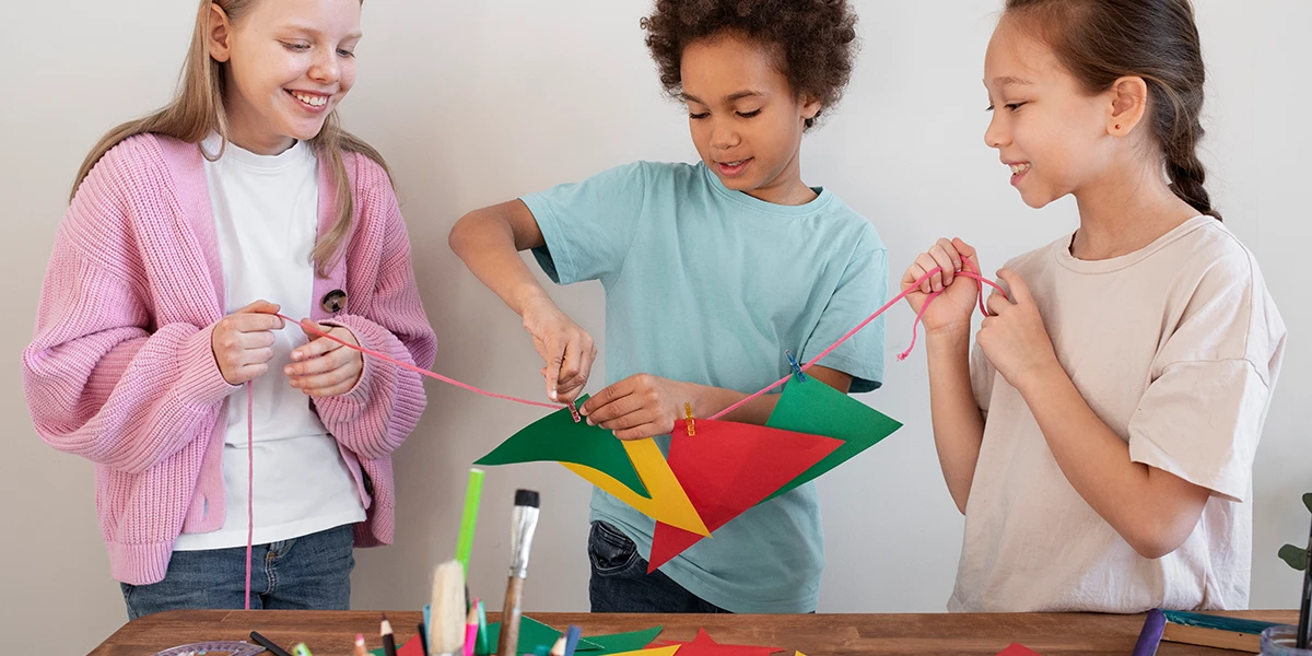 Young kids making DIY project from upcycled materials