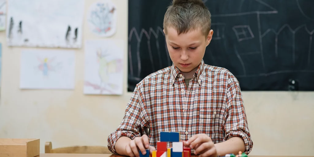 little boy playing with blocks