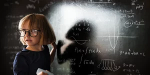 Little genius girl solving mathematics in the classroom