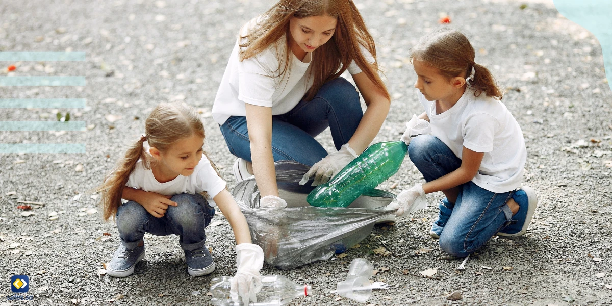 Preschool children helping clean the street from plastic accompanied by an adult