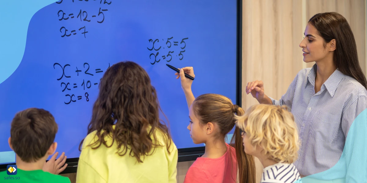 Teacher teaching math to a group of students using a giant digital screen.