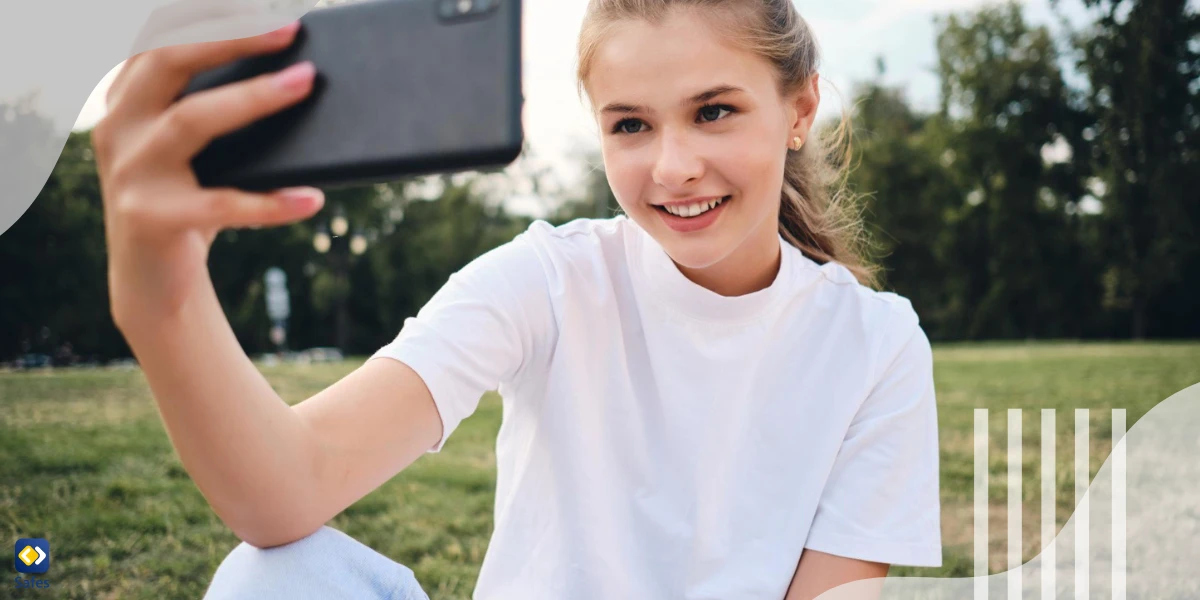 Mädchen macht ein Selfie in einem Park