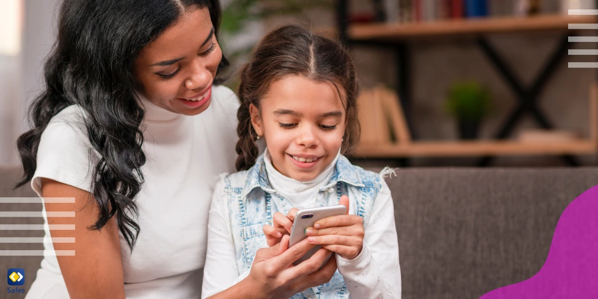 Mother and child discussing online safety holding a phone