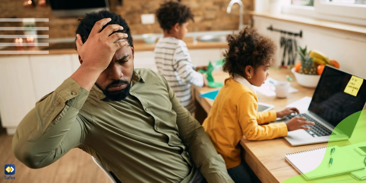 Father holding his head while child uses laptop