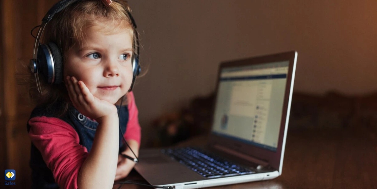 little girl with headphones staring while Facebook is open on her laptop