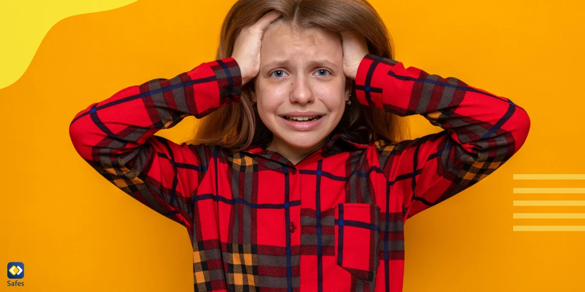 Girl with long sleeves and hands in her hair being upset