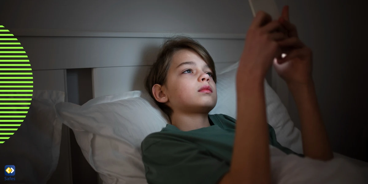 Young boy looking chatting in bed