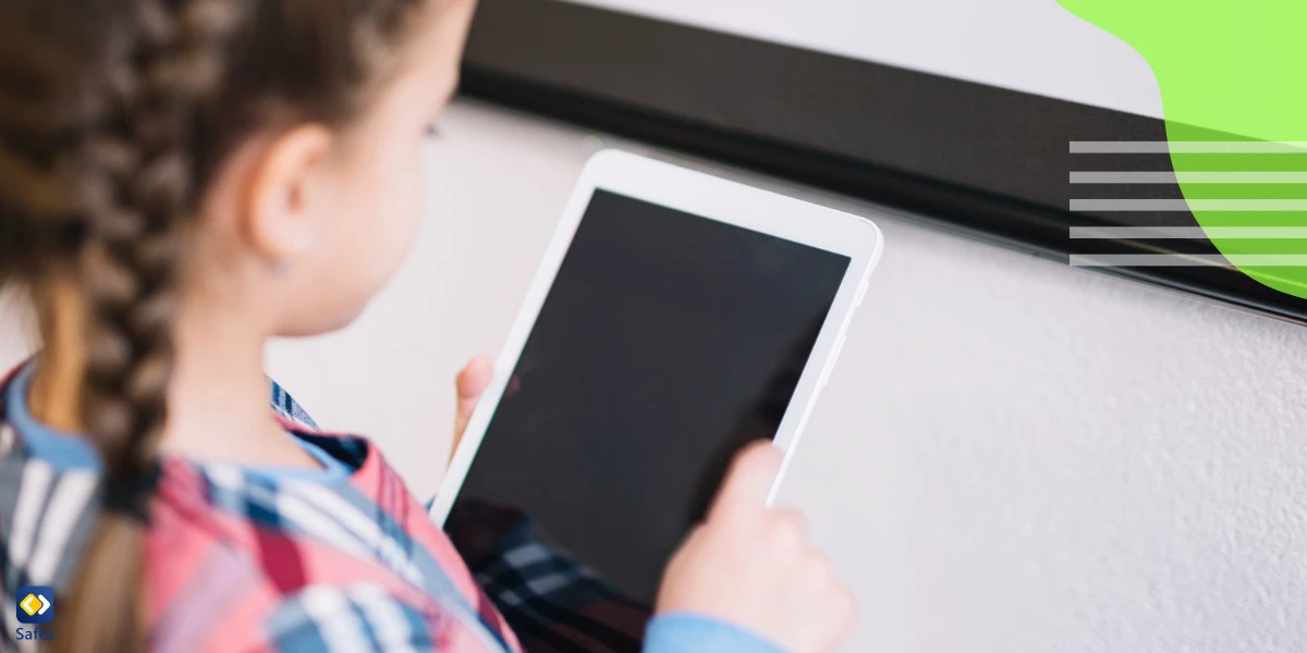 a little girl is using a digital tablet