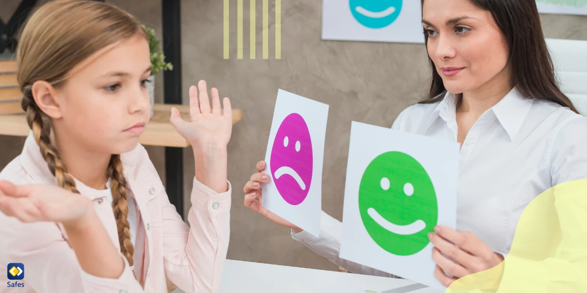 a woman is showing 2 emotion cards to a baby girl